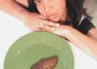The poop on the plate is being served to a woman