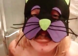 Wearing a kitty mask and playing with lots of poop