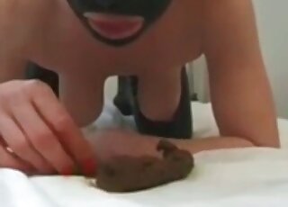 Masked bitch is shitting and pissing on it after